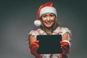 Girl With Santa Hat And Tablet photo