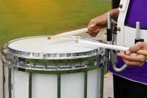 Some blurry images of Asian students playing drums during a parade practice. Soft and selective focus. photo