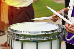 Some blurry images of Asian students playing drums during a parade practice. Soft and selective focus. photo