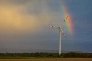 windmill in the nature with small rainbow photo