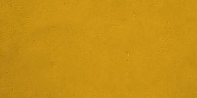 Urban background rusty cement or stone painting of gold yellow. photo