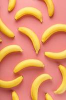Geometric pattern of bananas on a pink background. photo