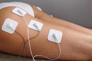 Muscle stimulator with electrodes, bacBack and shoulder massage with a muscle  stimulator with attached electrodes along the spine. 13725631 Stock Photo  at Vecteezy