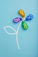 Colorful Stationery correction tapes in the shape of a flower on a blue background. photo