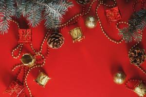 Christmas decorations with spruce branches on a red background with free space. photo