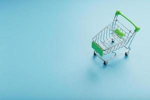 Empty miniature supermarket shopping cart on blue background photo