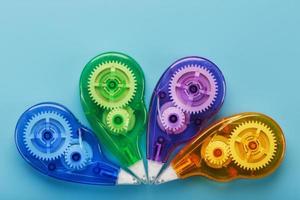 Stationery correction tapes are Multicolored on a blue background. photo