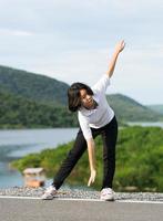 Woman doing exercising and warm up outdoor photo