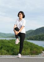 Woman doing exercising and warm up outdoor photo