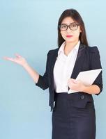 Young women standing with finger pointing up photo