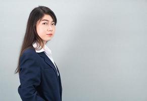 Portrait of asian business woman standing on gray photo