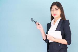 Asain women in suit standing using her digital tablet photo