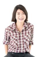 Young woman in a plaid shirt posing in studio on white photo