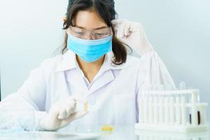 Scientist holding Omega 3 capsule in labcoat photo