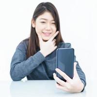 Woman using mobile phone and  writing notebook photo