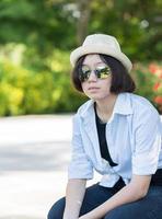 Women with short hair wearing hat in park photo