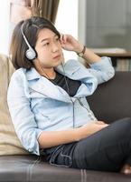 Woman short hair listening music in living room photo