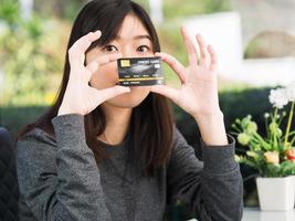 Close up young woman holding credit card photo