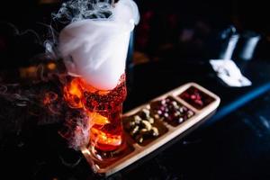 beautifully decorated cocktail in a nightclub, people drink a drink photo