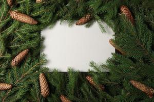 New Year's Eve background with fir branch and cones. Christmas and New Year holidays composition of pine tree branches. photo