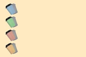 Four multi-colored cardboard coffee cups with a plastic lid on a beige background. Template with copy space. The concept of ecology, recycling, environmental protection. photo