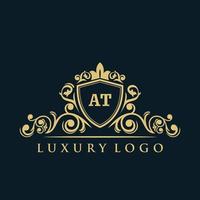 Letter AT logo with Luxury Gold Shield. Elegance logo vector template.