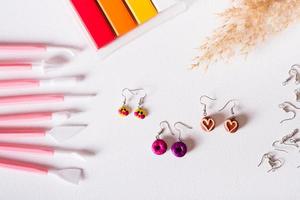 Polymer clay earrings, material and tools for work. Handmade. Top view. photo