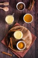 Turmeric honey golden milk in glasses. Home treatment, improve immunity. Top and vertical view