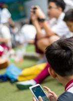 BANGKOK THAILAND - April 19,2018 Many student playing with smartphone during the brake time in school photo