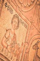petra, jordania, 2022 - los humanos se enfrentan al arte del mosaico en el piso de la iglesia bizantina en el sitio histórico de petra foto