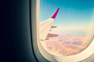 Cinematic copy space travel Airplane window view to amazing landscape of wadi rum desert in Jordan middle east. Concept of travel and air transportation. Visit Jordan concept photo