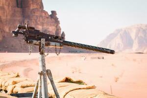 Old machine gun on wagon in wadi rum desert train ride in Jordan photo