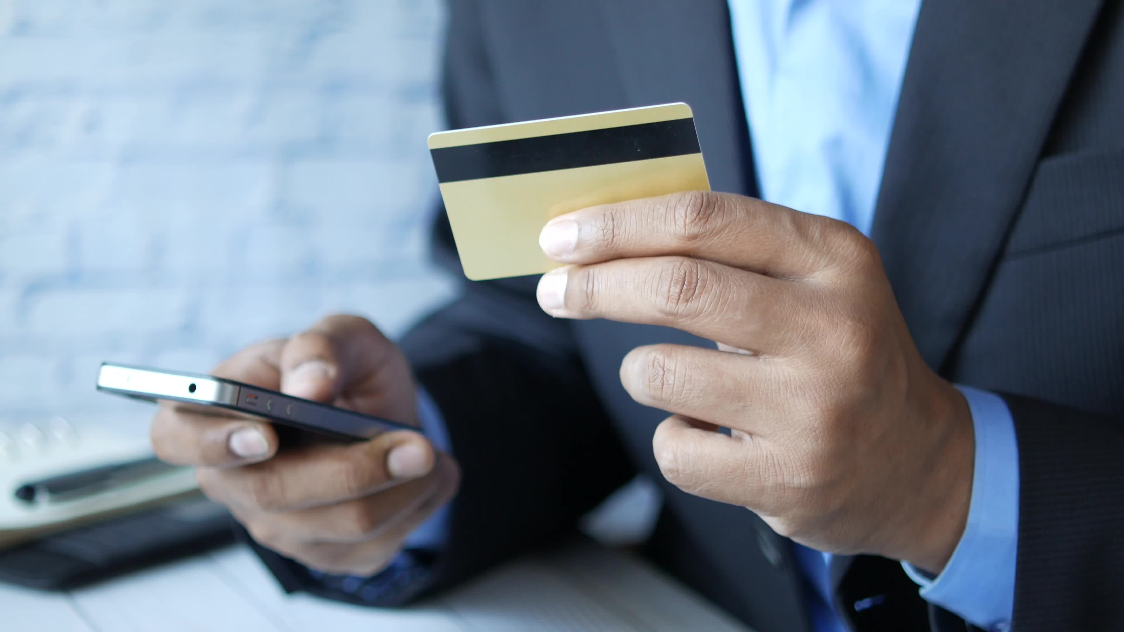 Man typing his credit card data on smartphone 13746416 Stock Video at