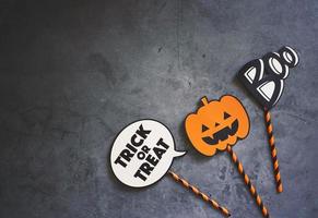 Flat lay of halloween prop for photo booth and party on dark stone background with copy space, holiday concept