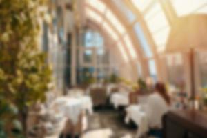 Blur background luxury cafe or restaurant interior with vintage style tone photo