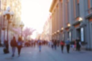 Blurred abstract background of people walking in street in the city, travel concept photo