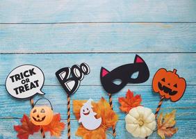 Flat lay of halloween prop for photo booth and party on blue wooden background with copy space, holiday concept