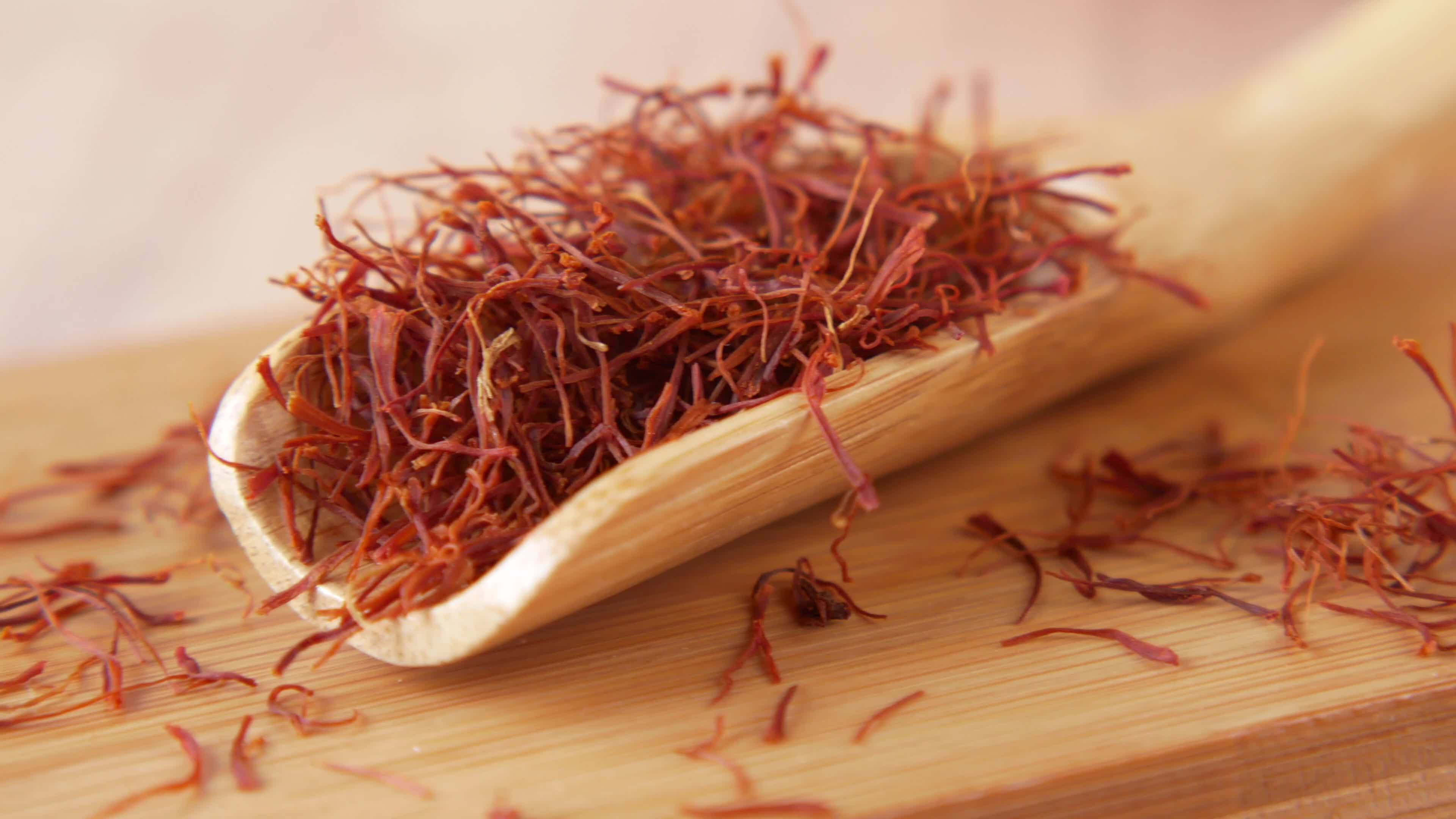 A small wooden spoon of spanish saffron 13747414 Stock Video at Vecteezy