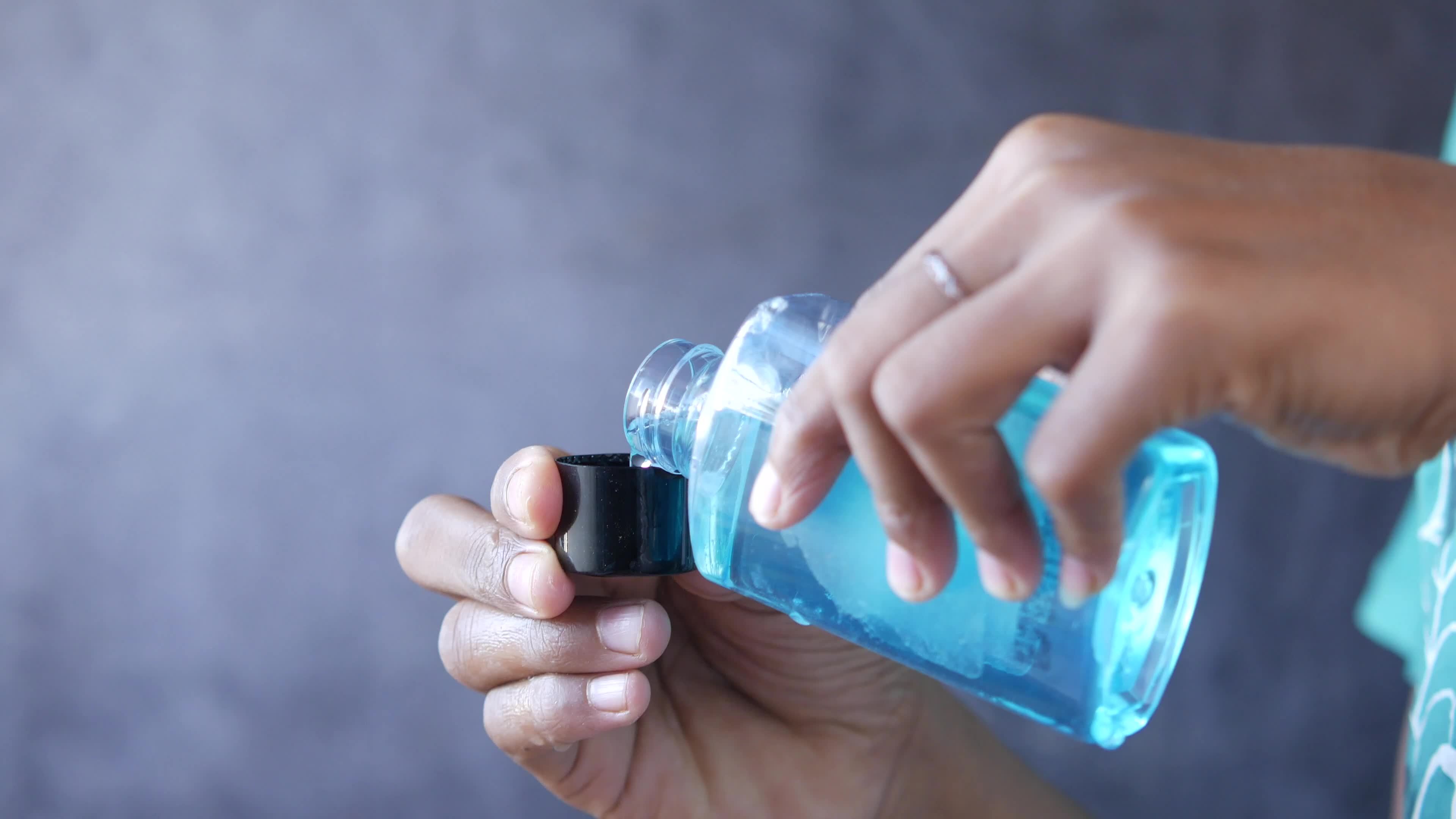 Getting a dose of mouthwash in the lid 13748037 Stock Video at Vecteezy