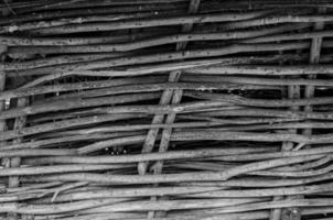 fence made of tree branches boards photo