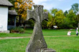 Ancient wooden Cross  on fence photo