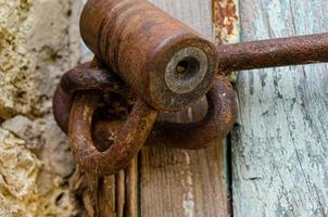 Lock on an old wooden door with rusty inserts photo