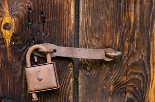 cerradura en una antigua puerta de madera con inserciones oxidadas foto