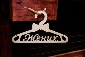 Two white wooden hangers groom and bride photo