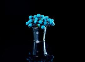 aluminum ice bucket laid in wait for use. stainless multi-colored bucket with green blue berries in ice photo