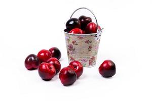 aluminum ice bucket laid in wait for use. stainless multi-colored bucket with red apples photo