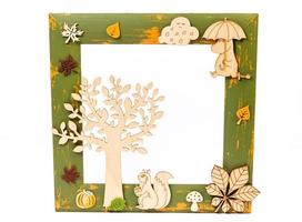 rectangular wooden frame decorated with colorful autumn leaves on a white background, space for text photo