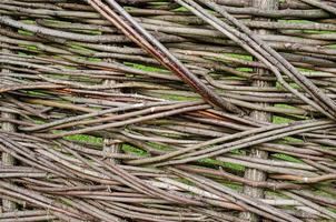 fence made of tree branches boards photo