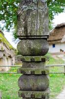 Ancient wooden cube  on fence photo