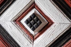 Ancient wooden cube  on fence photo